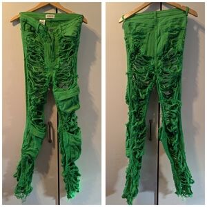 Distressed and shredded green denim pants